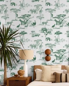 a bedroom with green and white animal wallpaper