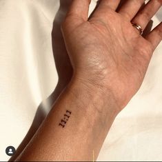 a person's arm with the word life tattooed on it, in black ink