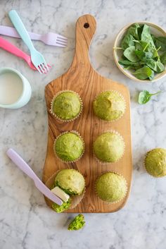 green cupcakes on a cutting board next to other food items