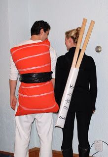 a man and woman dressed up in costumes with baseball bats on their backs, standing next to each other