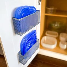 there are many blue dishes in the refrigerator