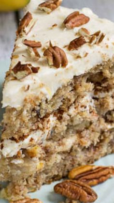 a piece of carrot cake with cream cheese frosting and pecans