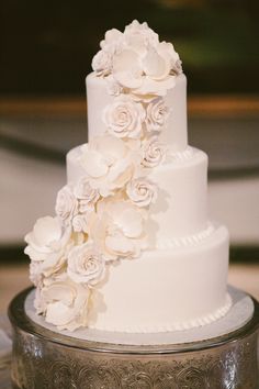 a wedding cake with white flowers on top