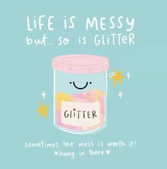 a jar filled with glitter sitting on top of a blue surface next to stars and the words, life is messy but so is glitter