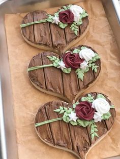 three heart shaped cookies with flowers on them