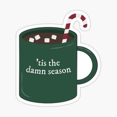 a green mug with a candy cane in it and the words,'tis the damn season