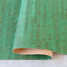 a green wallpaper with gold speckles on the top and bottom part,