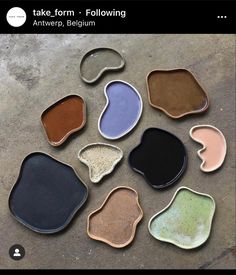 nine different colors of clay sitting on top of a cement floor next to each other