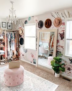 a room with many hats on the wall and a pink ottoman in front of it