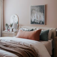 a bedroom with pink walls and white bedding