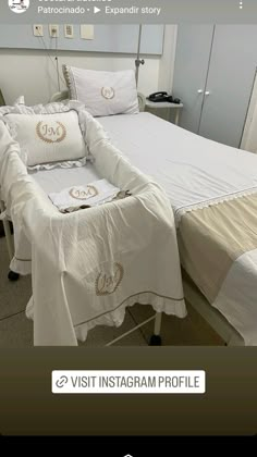 a bed with white sheets and pillows on it