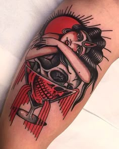 a tattoo with a woman holding a skull on her arm