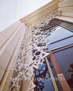 the side of a building with an intricate design on it's glass window sill