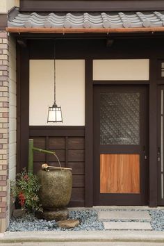 the front door of a building with a large potted plant