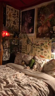 a bed in a bedroom with pictures on the wall above it and lights at night