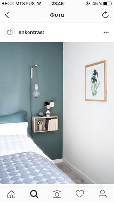 a bed sitting next to a green wall in a bedroom