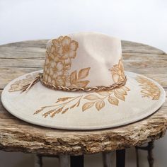 Burned Hat in a color called Natural Beige. Burned using pyrography techniques. All original art applied freehand. Hat is adjustable for a tighter fit. Each hat is a one of a kind. All hats made by PIPER are sealed for weather and wear and come with a signature Dust/Travel Bag and a handcrafted macramé hat wall hanger. Design: Original Art: Jasmine Flowers and leaves. Pyrography Techniques, Hat Wall, Jasmine Flowers, Hanger Design, Wide Brimmed Hats, Brim Hat, Pyrography, Hat Making, Wide Brimmed