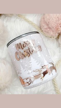 a white christmas canister sitting on top of a fluffy blanket next to a teddy bear