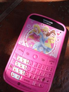 a pink cell phone sitting on top of a table