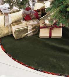 presents under the christmas tree are wrapped in gold paper