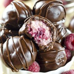 raspberry chocolate truffles are stacked on top of each other in a bowl