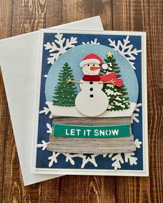 a card with a snowman on it and the words let it snow written below