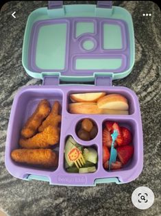 a purple lunch box filled with food on top of a marble countertop next to a blue plastic container