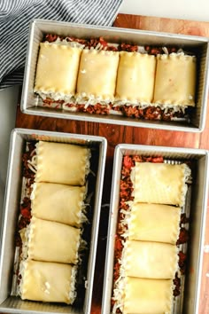 three pans filled with food sitting on top of a wooden table