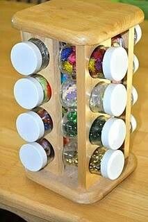 a wooden container filled with lots of different types of buttons and thread spools