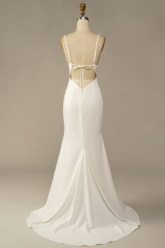 the back of a white wedding dress on a mannequin headdress,