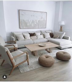 a living room filled with furniture and a painting on the wall