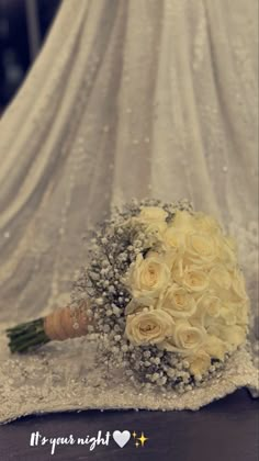 a bridal bouquet with white roses and baby's breath