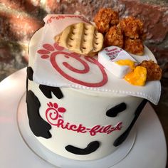 a cake decorated to look like a cow with cookies and crackers on it's top