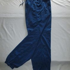 Nike Leisure Pants - Royal Blue - (M 8-10) Nwot Nike Leisure Pants With Drawstring Elastic Waist, Zipper On Each Lower Leg With Elastic Hem, Three (3) Pockets; One On Each Side With An Additional Tab Velcro Inner Pocket To Secure Keys, Cash, And I.D.; Can Be Worn Over Swim/Workout. Size M/8-10. Approx. Measurements Are: 25 ¼” Around/Diameter Without Elastic Stretch, Stretch To 16” Flat (32”), Hips 22” Flat (44”), Inseam 31 ½”, Ankle Zipped With No Stretch 10 ¼” Around/Diameter, Zipper On Leg 12” Nike Cotton Long Pants, Nike Blue Relaxed Fit Sweatpants, Solid Cotton Nike Pants, Solid Color Cotton Nike Pants, Blue Stretch Straight Leg Cargo Pants, Nike Cotton Bottoms In Solid Color, Nike Cotton Pants For Spring, Nike Cotton Bottoms, Nike Bottoms With Elastic Waistband And Relaxed Fit