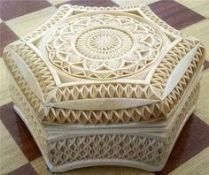 a wooden box sitting on top of a checkered floor