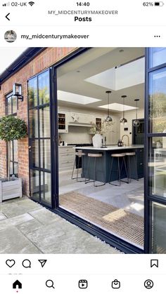 an open kitchen and living room are seen through the glass doors