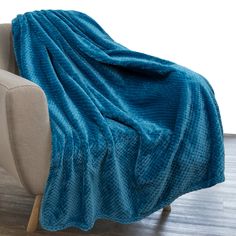 a blue blanket sitting on top of a couch