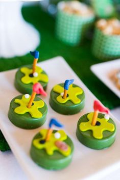 some green cupcakes with candles on them