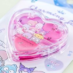 Have fun experimenting with your makeup by using this colorful melon-scented palette! It has a lip color and two vibrant eyeshadows, and a mini eyeshadow applicator! This super cute makeup set comes in a transparent plastic case shaped like a heart that has kawaii prints of popular Sanrio characters like Pochacco, the Little Twin Stars, Hello Kitty, and more! The makeup palette is safe for almost all skin types and children can use this palette as well. A super cute heart-shaped lip color and ey Cute Makeup Set, Toddler Makeup, Kawaii Prints, Macaron Lip Balm, Pixie Makeup, Makeup Ingredients, Hello Kitty Crochet, Alat Makeup, Hello Kitty Videos