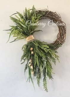 a wreath with greenery hanging on the wall