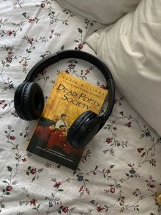 there is a book and headphones on the bed