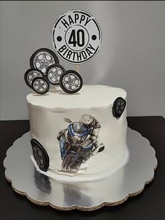 a birthday cake decorated with an image of a man on a motorbike and the number forty