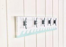 a wall mounted coat rack with five hooks