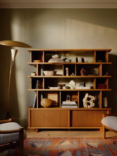 a living room with a large wooden shelf