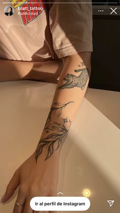 a person with a dragon tattoo on their arm