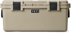 a tan yeti cooler is shown with black handles and latches on the lid