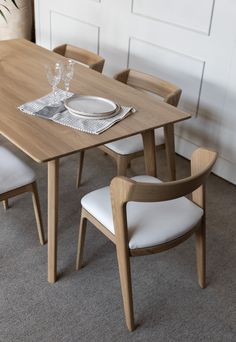 a wooden table with white chairs around it