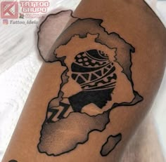 a black and white photo of a tattoo on someone's arm with the map of africa