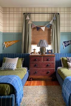 two twin beds in a bedroom with blue and green decor