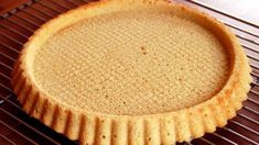 an uncooked pie sitting on top of a cooling rack